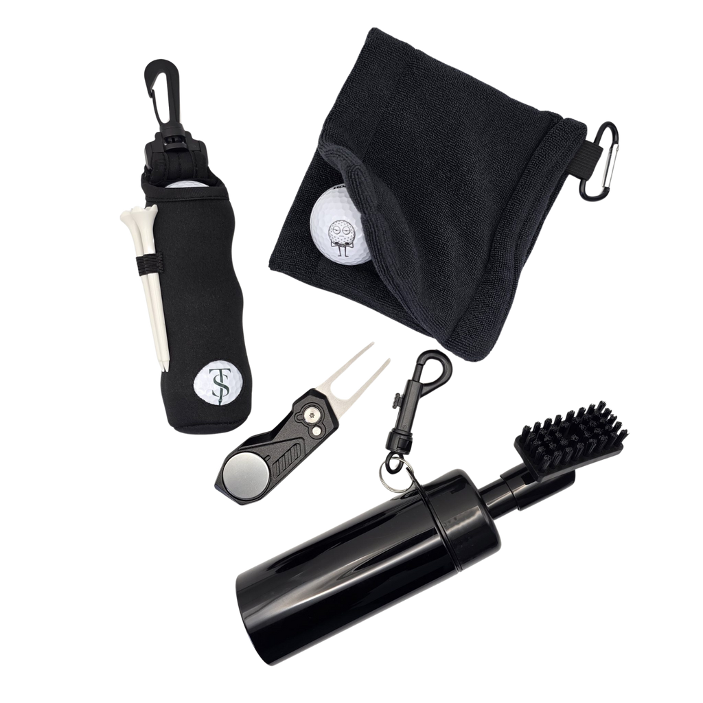 Golf accessories arranged together: black ball pouch, cleaning towel, divot tool with marker and spray brush.